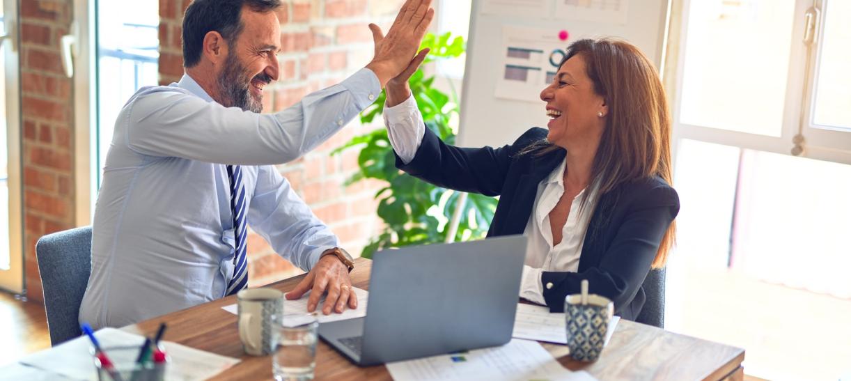 Foto de un hombre y una mujer juntando las palmas en una oficina. Ilustra nota sobre incentivos económicos por nuevos empleos.
