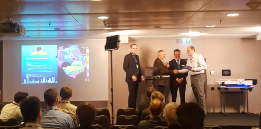 Dr. Wang's colleague accepting the 2016 FloEFD Frontloading CFD Award on her behalf. Image courtesy of Nazita Saye. All rights reserved.