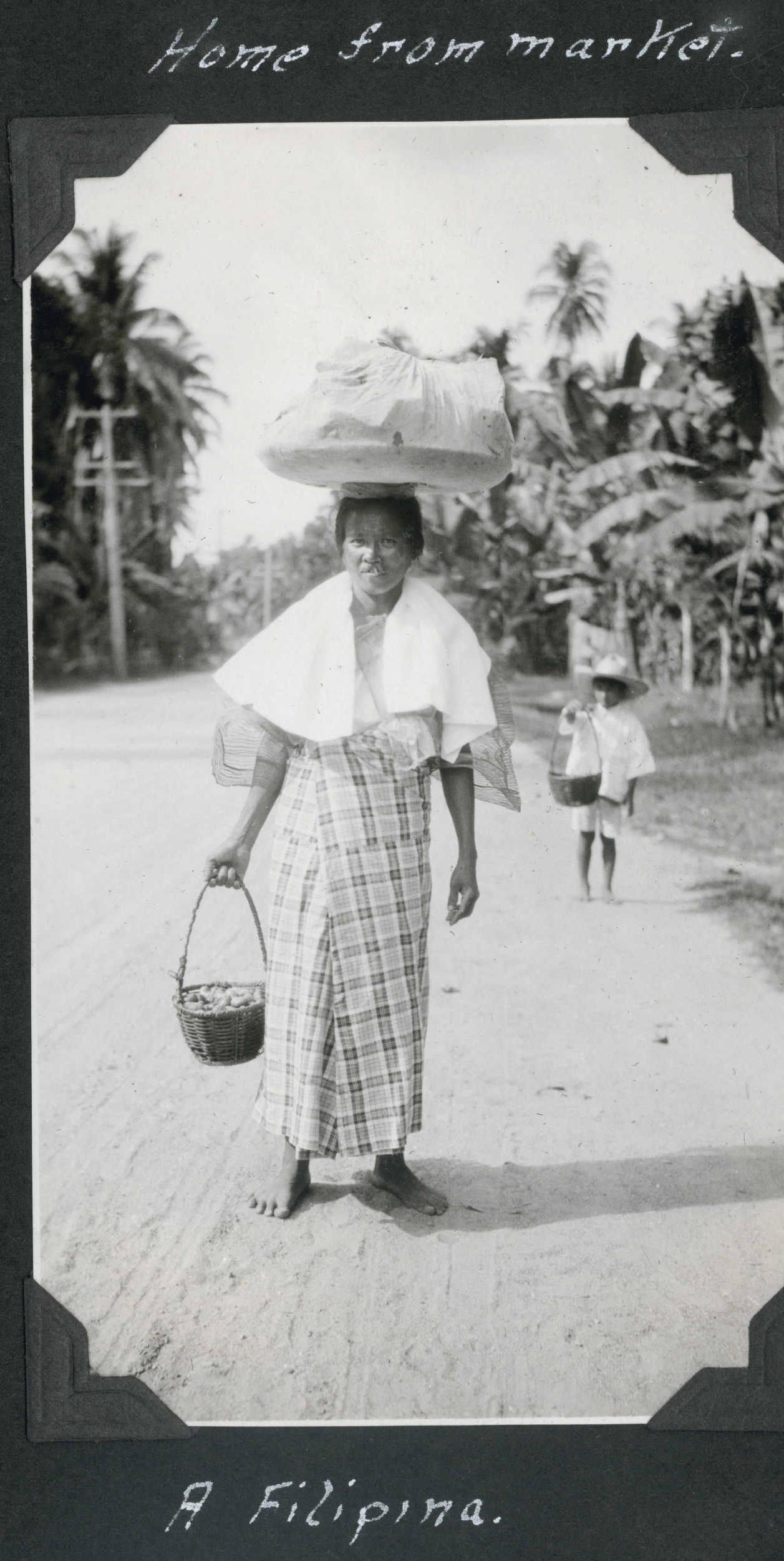 Home from market, a Filipina lady balancing her load
