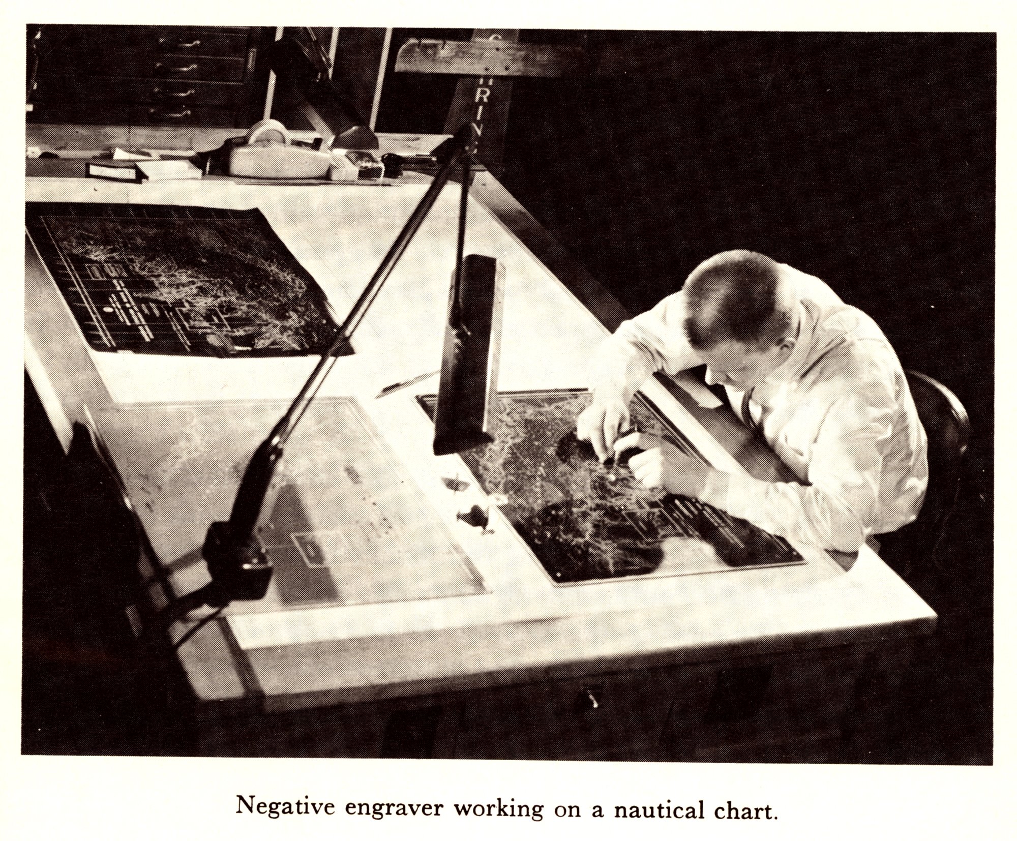 Negative engaver working on a nautical chart