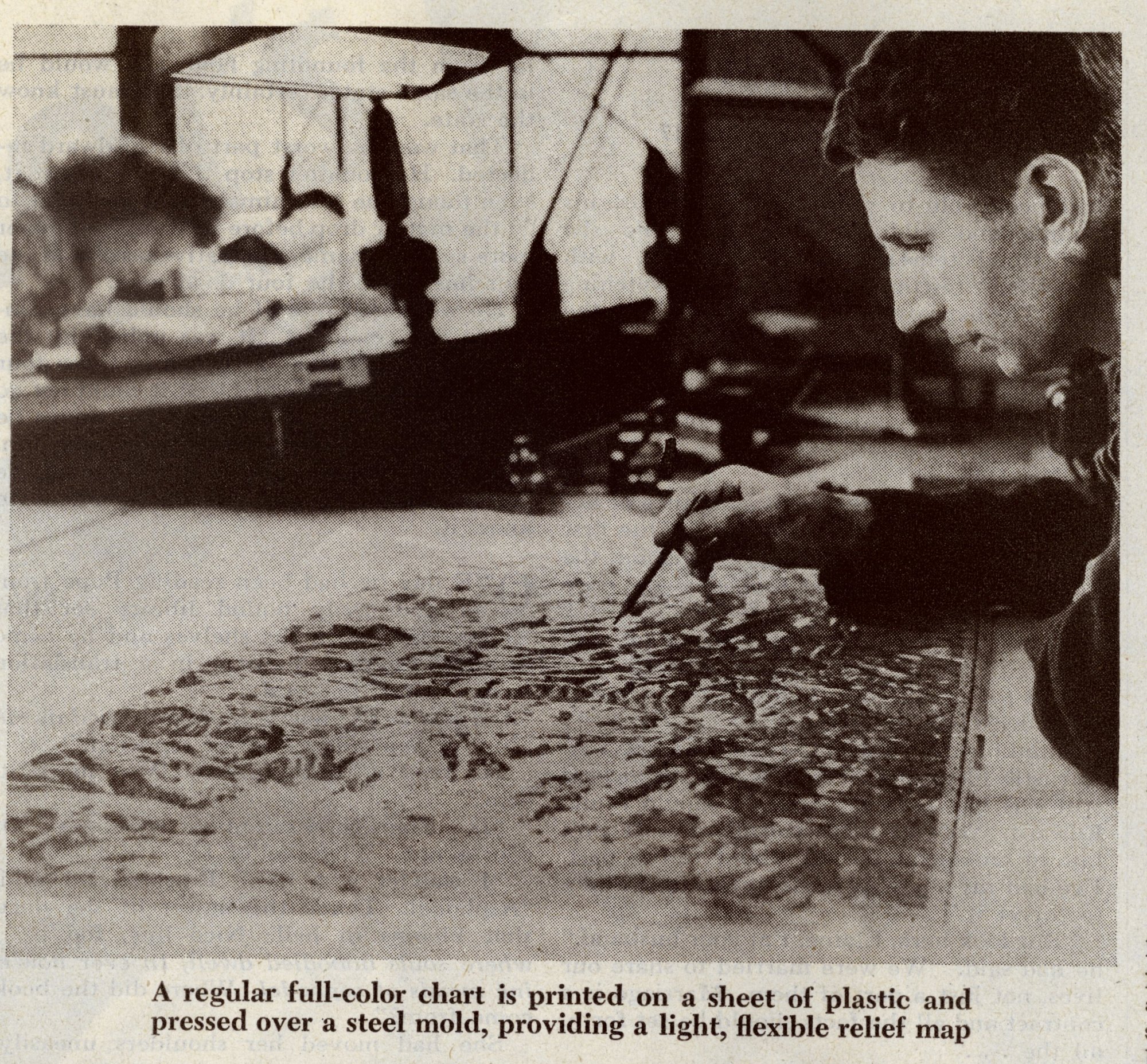 A regular full-color chart is printed on a sheet of plastic and pressed over asteel mold, providing a light, flexible, relief map