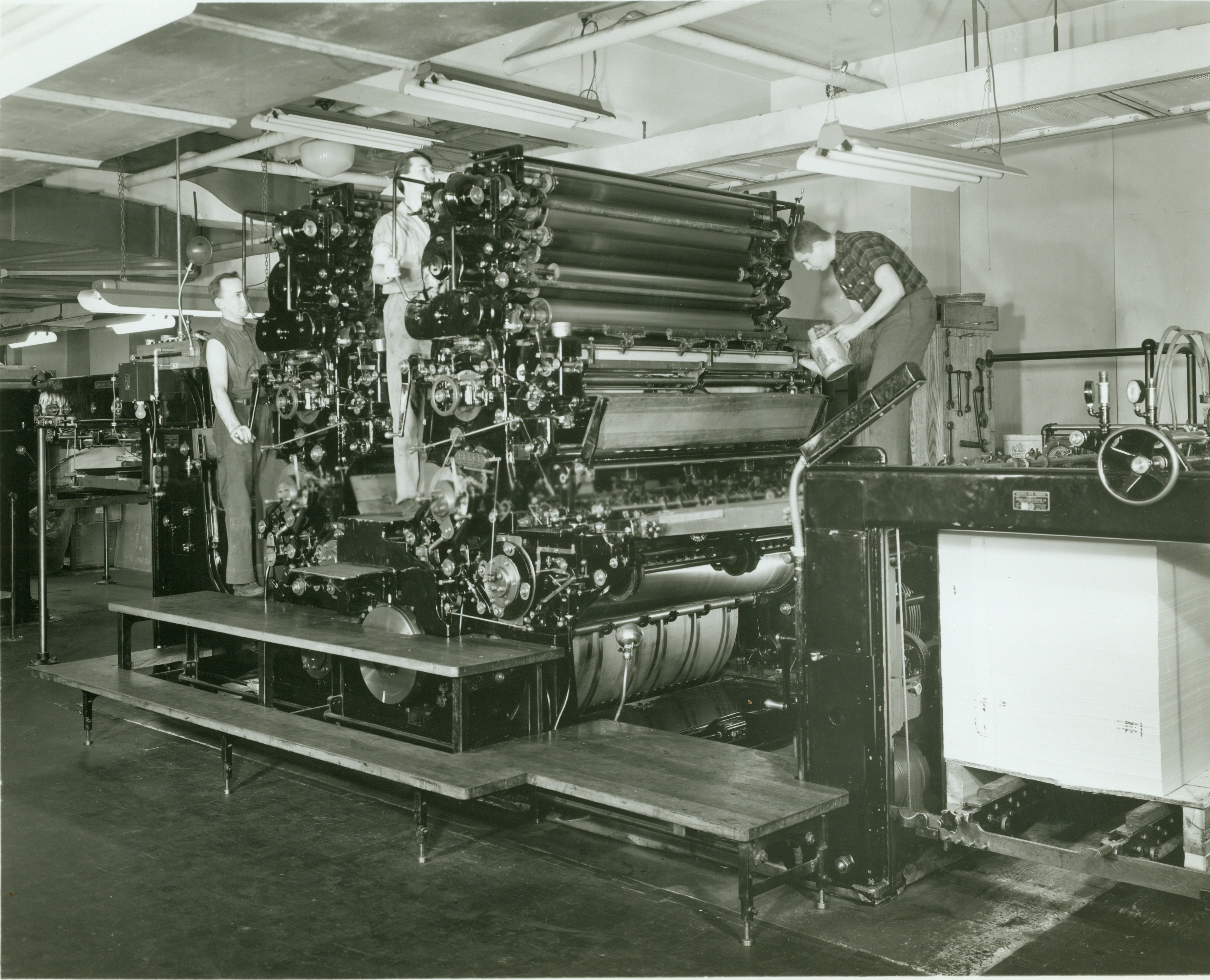 Coast and Geodetic Survey pressmen in action on a Harris press