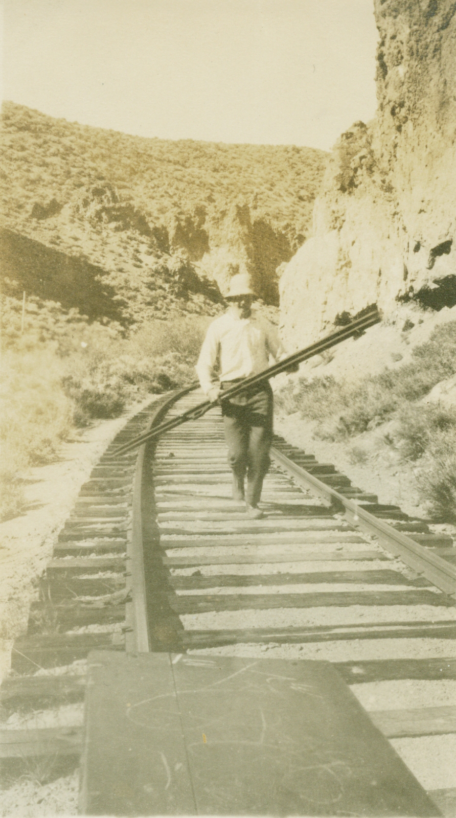 Rear rodman hustling to become forward rodman during leveling operations inthe Nevada desert