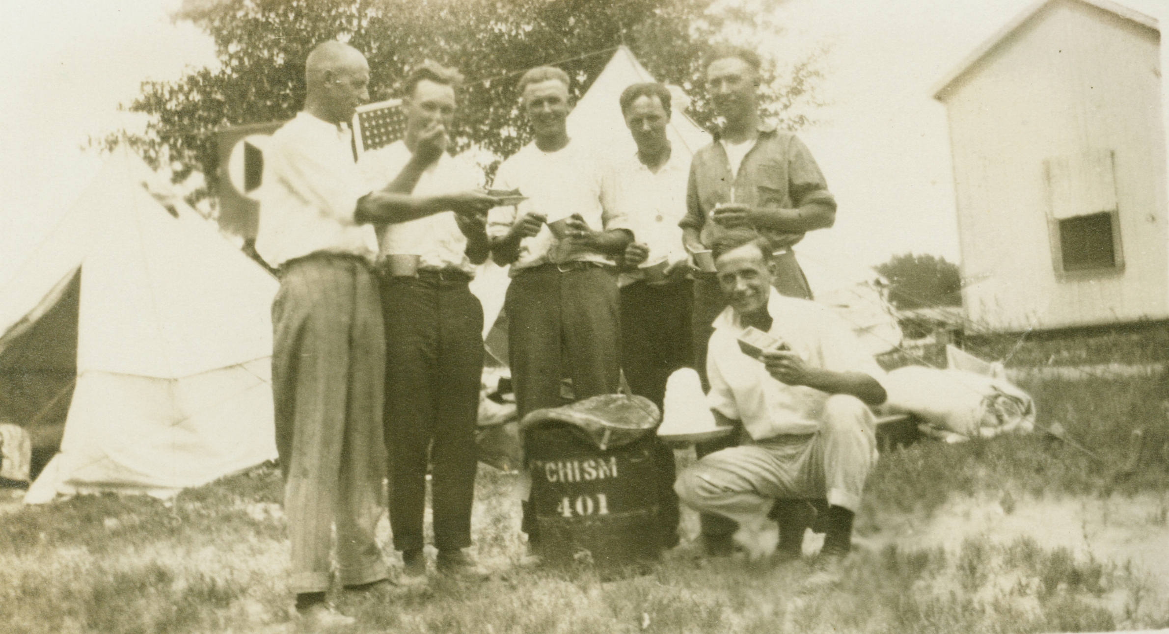 Survey crew with pie and ice cream in camp