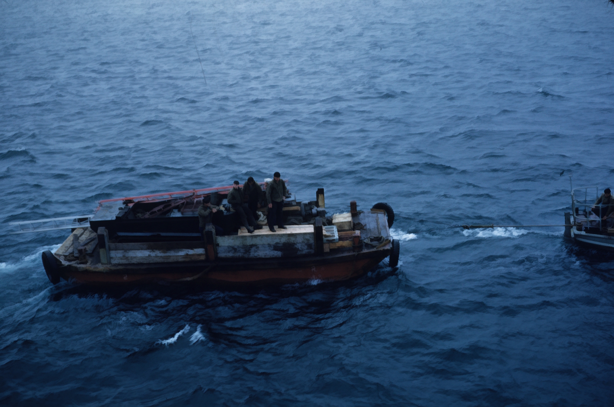 Building materials being taken to shore for shore camps at St