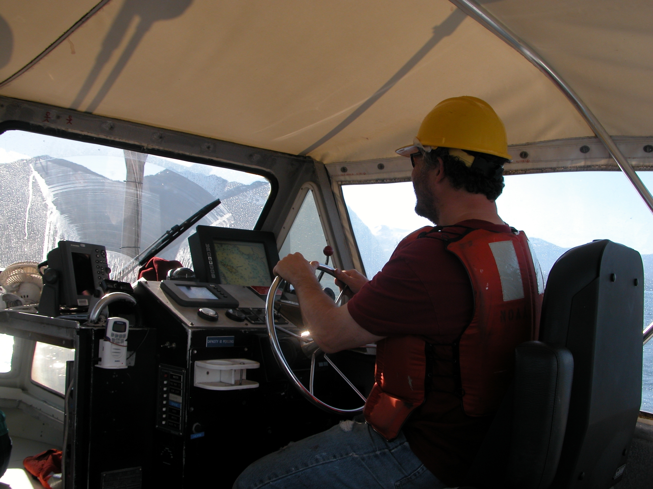 Coxswain of launch off NOAA Ship RAINIER keeping the boat on line whileoperating in SE Alaska