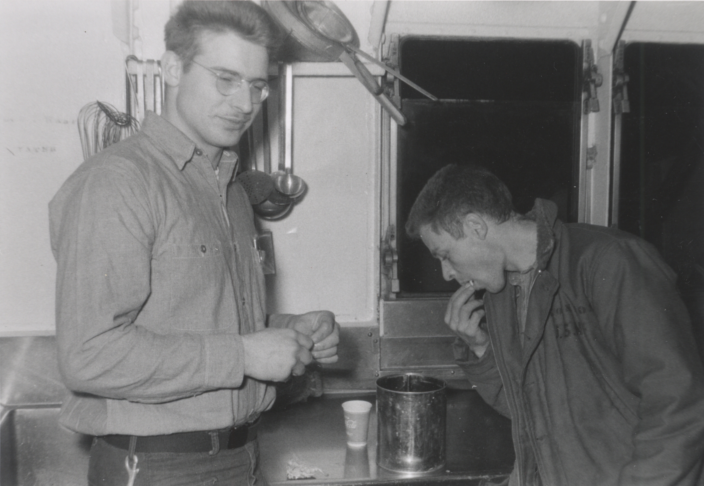 Laurel Savage on left and Third Assistant Engineer Tom Garten on  righteating shrimp caught off pier at Adak