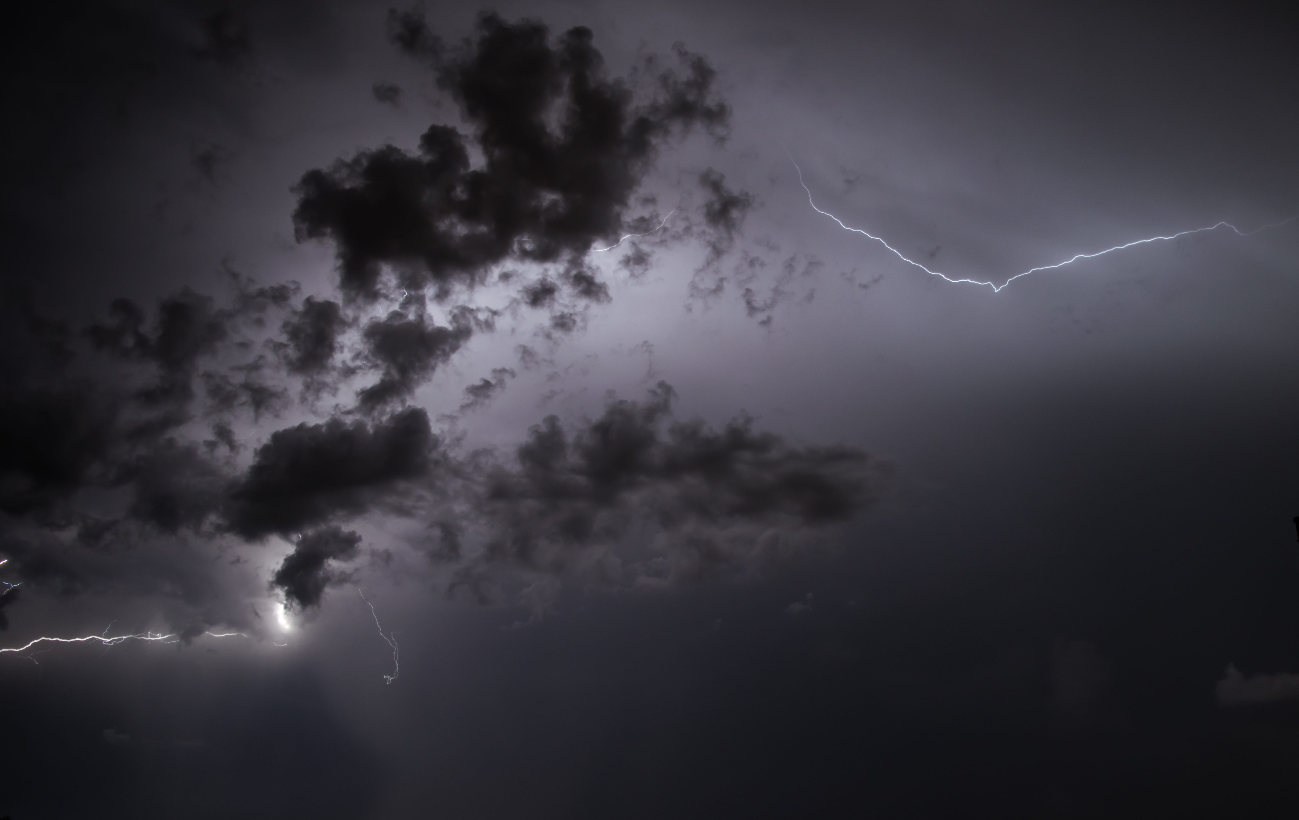 Beautiful streaks of lightning peeking from behind the clouds