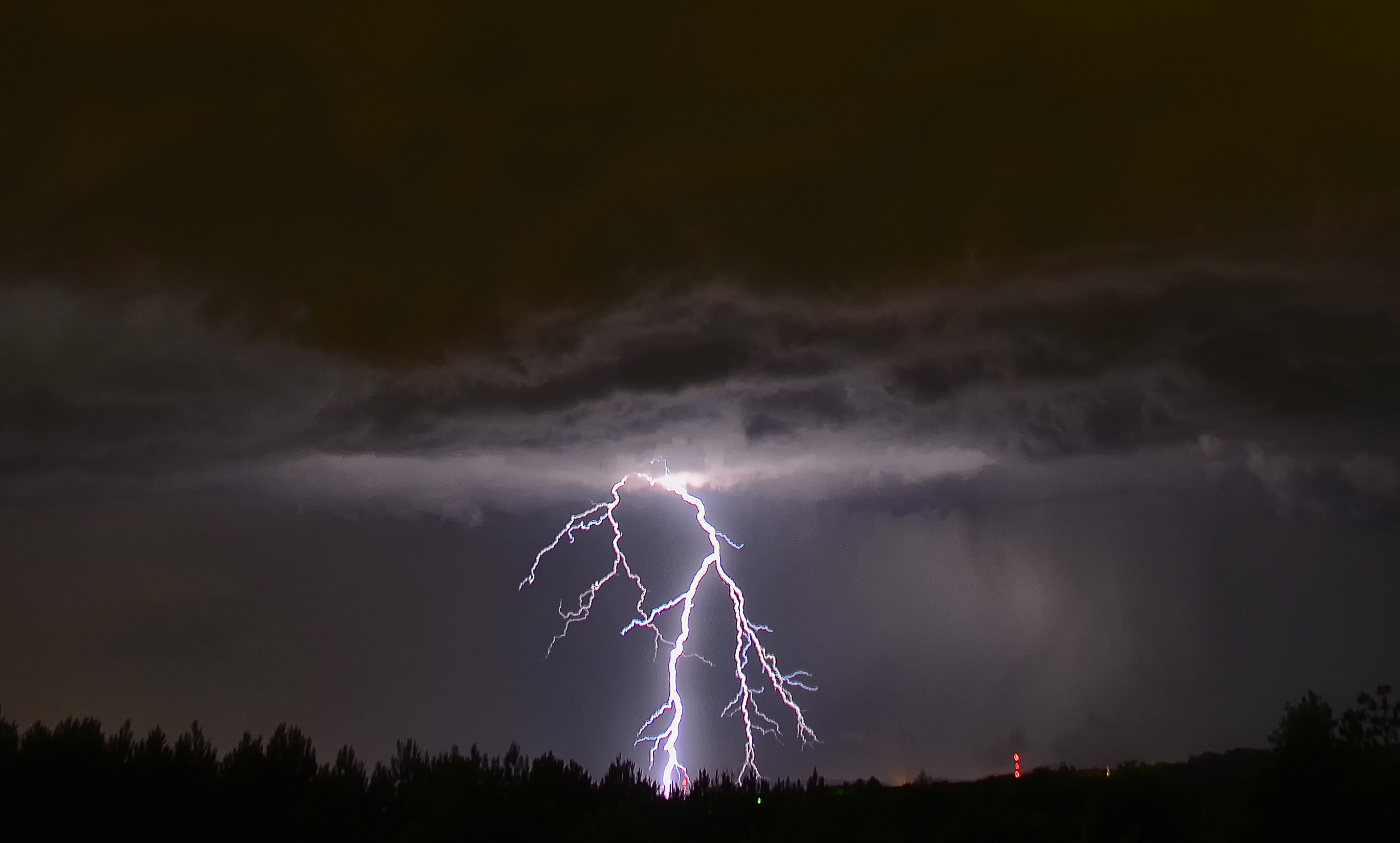 Lightning discharging from severe storm moving in behind my house