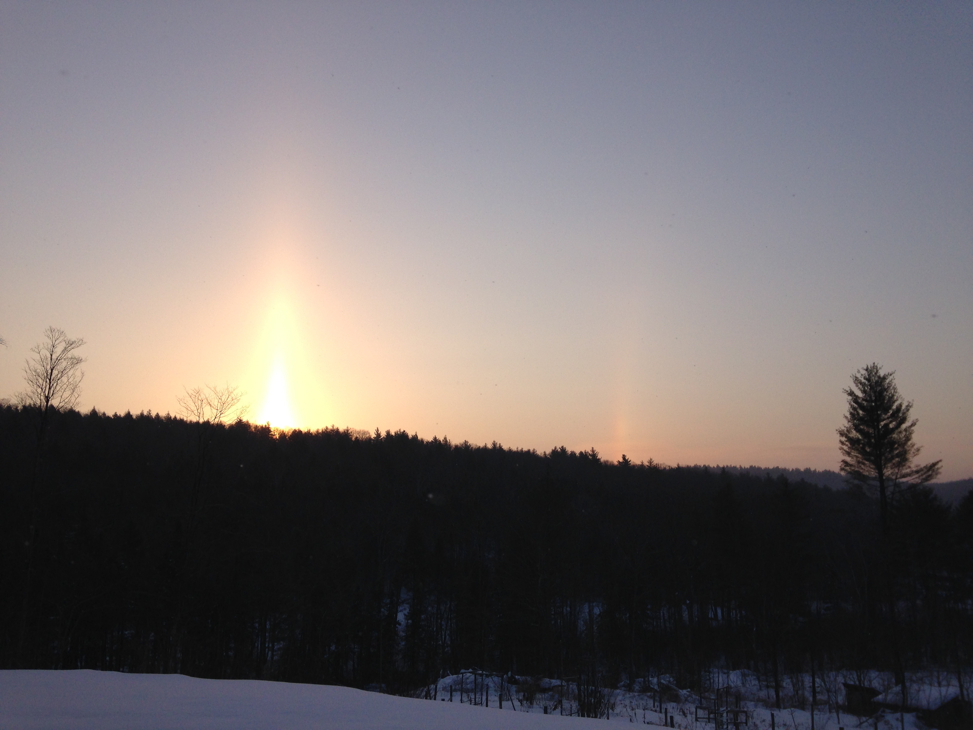 Sun pillar and sun dog before sunrise