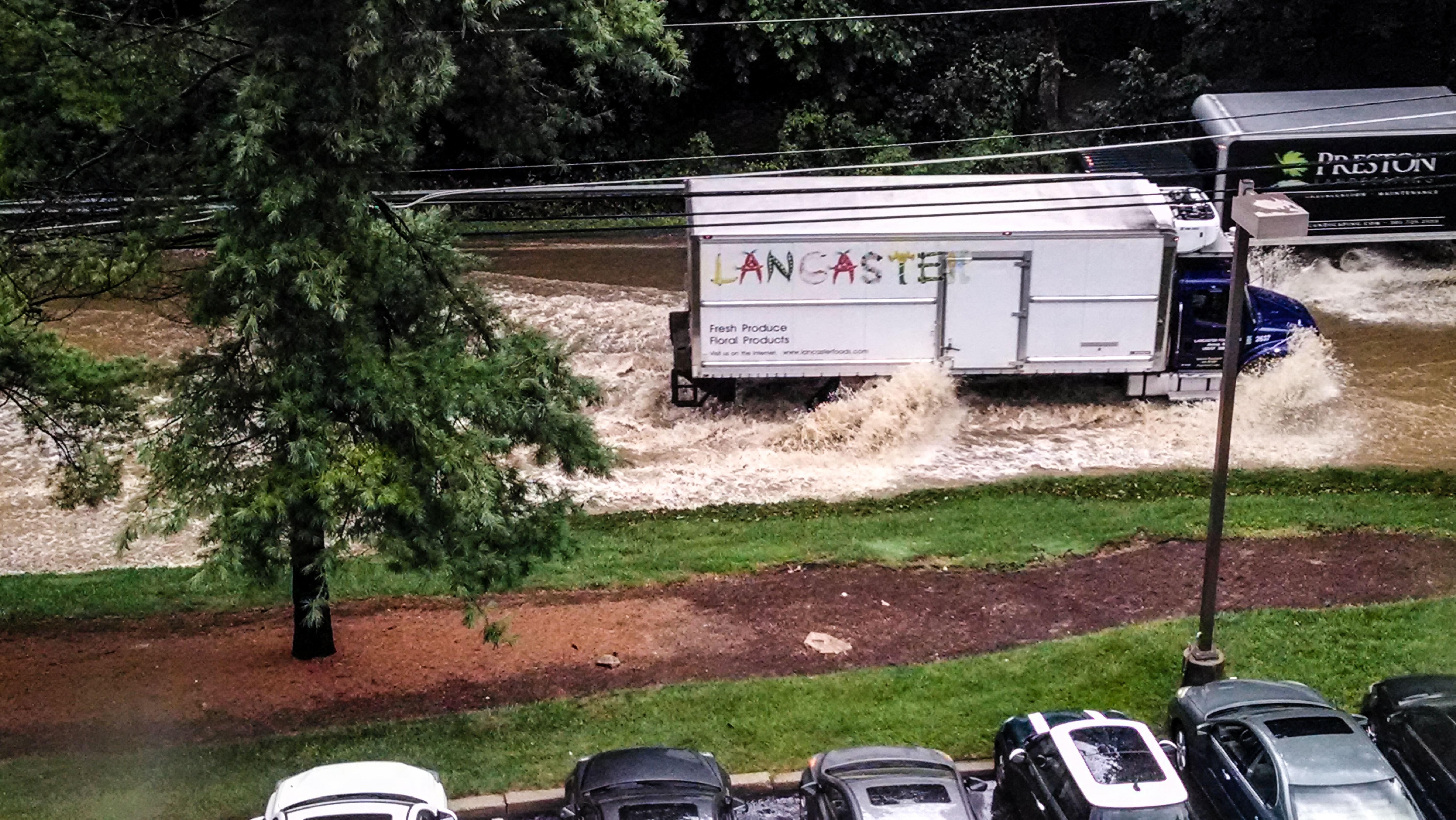 Traffic on Goldsboro Road, Bethesda tries to travel through flooding after amassive downpour causes Minnehaha Creek to overflow its banks