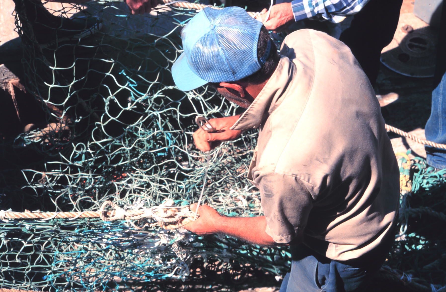 Mending nets on the dock - a timeless fishing skill
