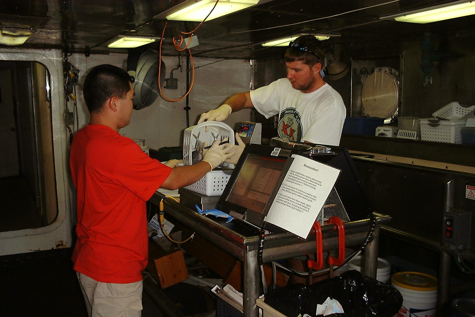 Scientists conducting laboratory studies on fish caught on NOAA ship GORDONGUNTER