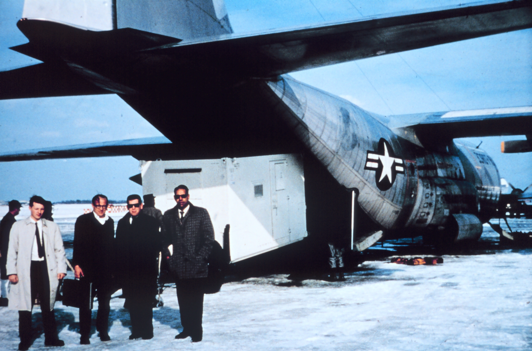 Loading satellite gear on an Air Force cargo plane