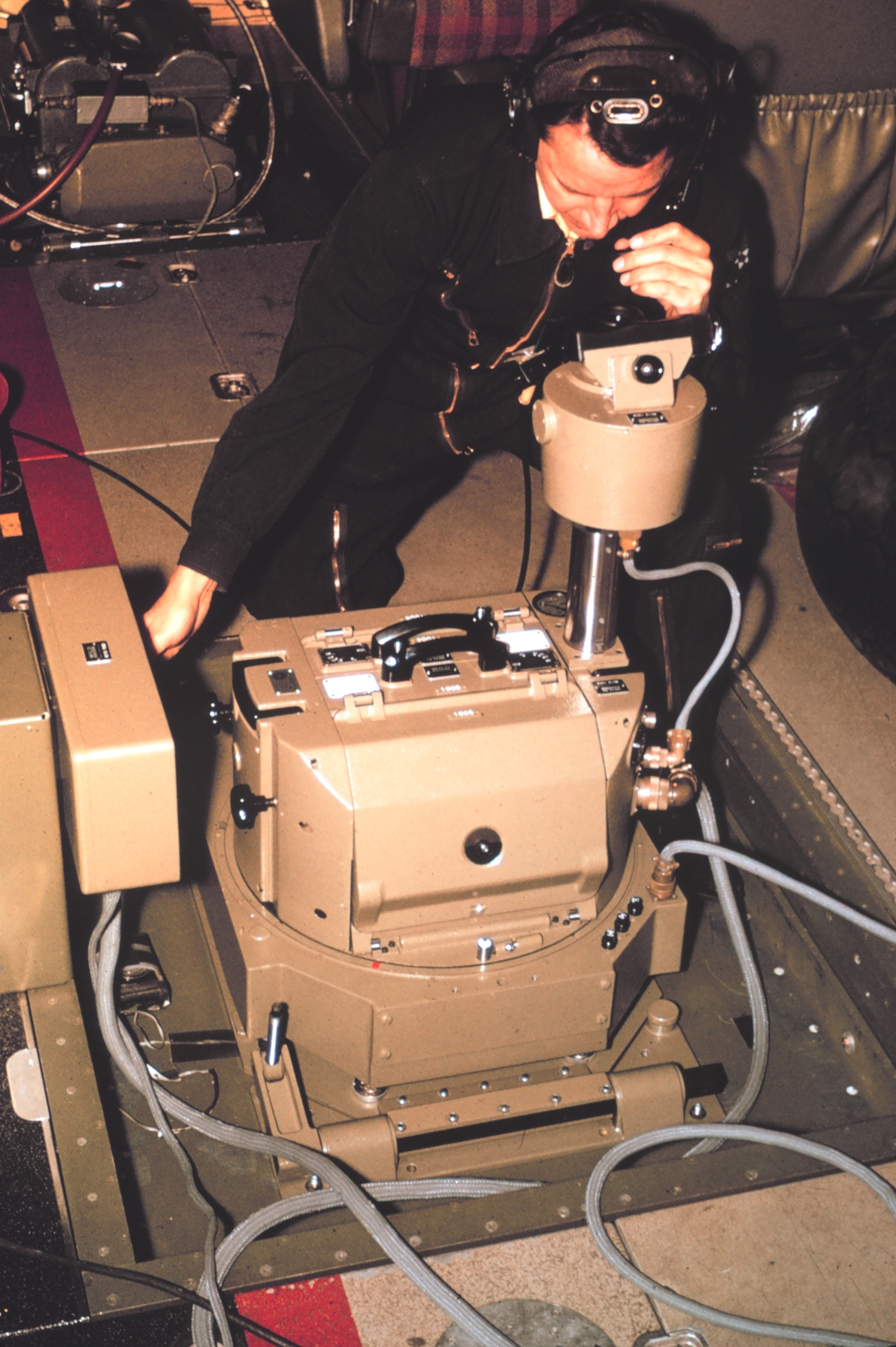 Aerial photographer, Charles Ferguson, operating Wild RC-10 camera installedon NOAA De Havilland Buffalo N13689