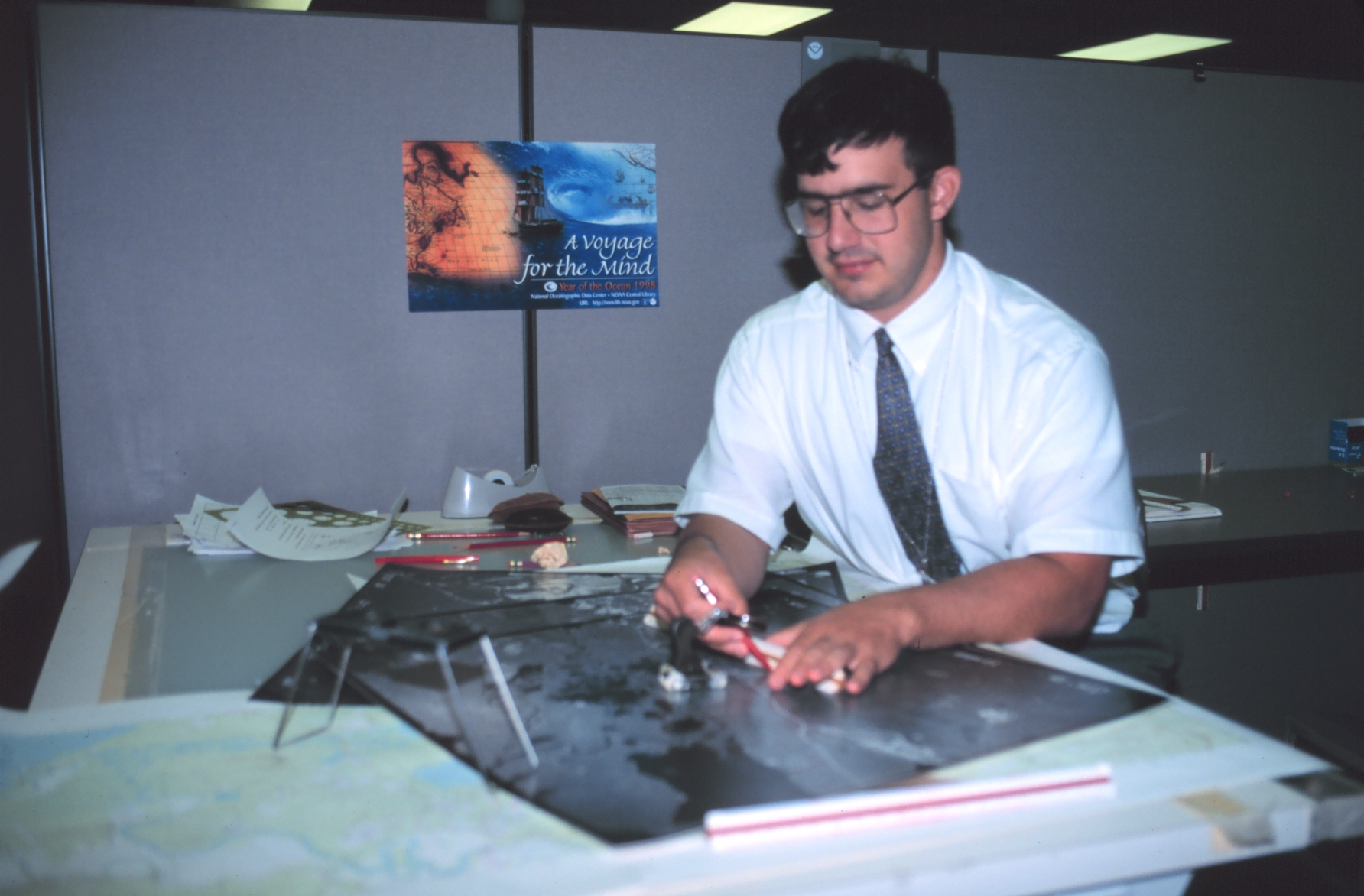 Greg Lasalla, a cartographer with the National Geodetic Survey Remote SensingDivision working with aerial photographs of an airport