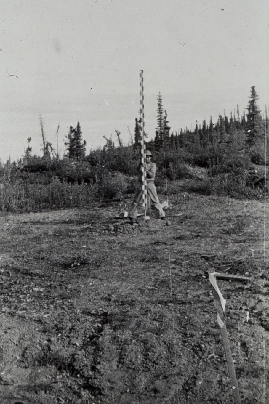 Rodman holding rod steady for observations