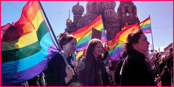 Image of people waving rainbow flags. The text reads: We made history in 2019. Let’s do it again in 2020. Donate.