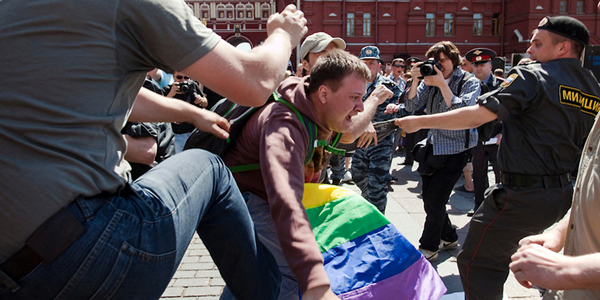 The image portrais a group of anti-LGBT+ protestors in Poland and reads Hate Sweeping through Europe. Donate