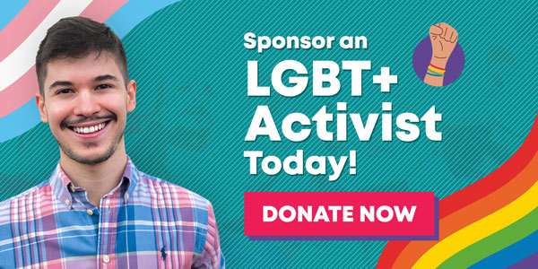 The image shows a young man smiling. He has brown hair, dark eyes and white skin. He is wearing a pink and blue shirt. Next to him, there's a text that reads Support an LGBT+ activist today. And a button that reads Donate Now