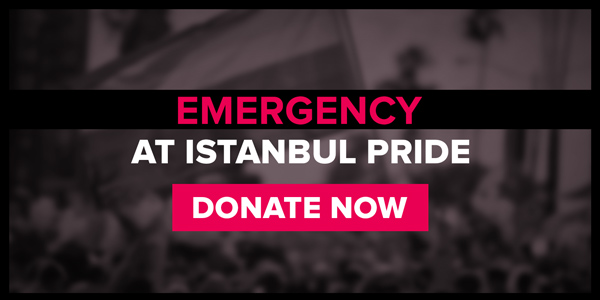 Out of focus black and white image of a protestor with a rainbow flag. Written over it is EMERGENCY AT ISTANBUL PRIDE. DONATE NOW.
