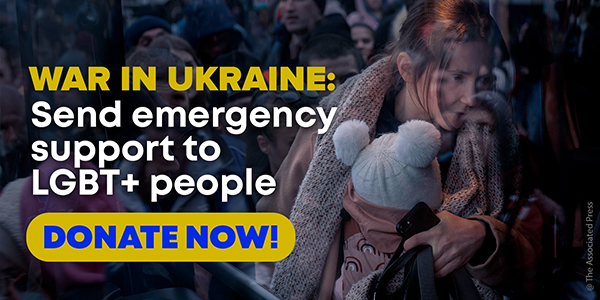The picture shows a group of refugees. A mother carrying a small child on her chest in the foreground. The text reads: War in Ukraine: Send emergency support to LGBT+ people. Donate Now