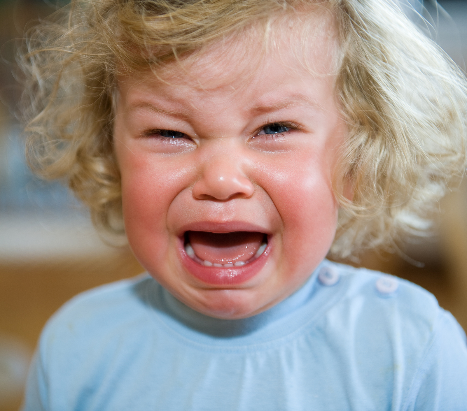 toddler with messy hair crying