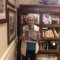 Tularosa Basin Museum of History docent Joann Tally hold a photo of her father who was in the Civilian Conservation Corps in the 1930s