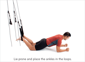 Lie prone and place the ankles in the loops.