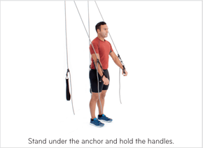 Stand under the anchor and hold the handles.