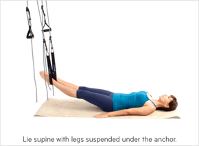 Lie supine with legs suspended under the anchor.