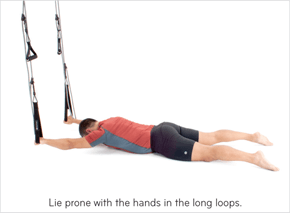 Lie prone with the hands in the long loops.