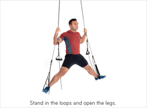 Stand in the loops and open the legs.