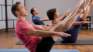 Photo of people working out on mats