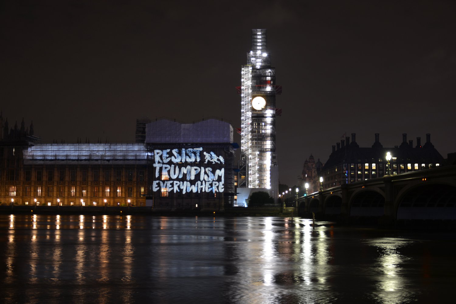 words resist trumpism everywhere projected onto the houses of parliament in london
