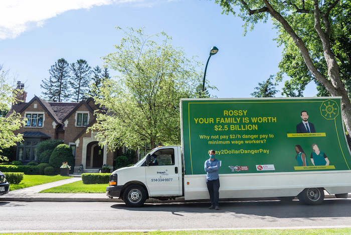 Worker rights billboard in front of Neil Rossy's mansion