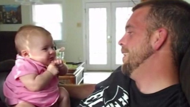 Begins to smile at people