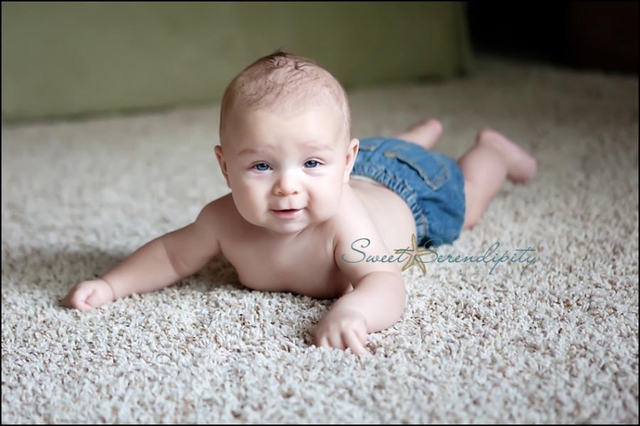 Can hold head up and begins to push up when lying on tummy