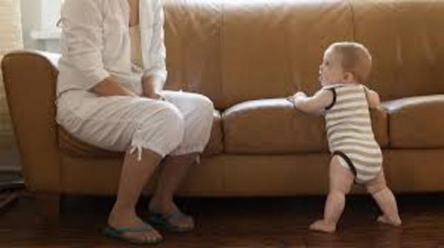 Pulls up to stand, walks holding on to furniture (“cruising”)