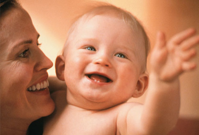 Baby smiles a lot, mostly to people