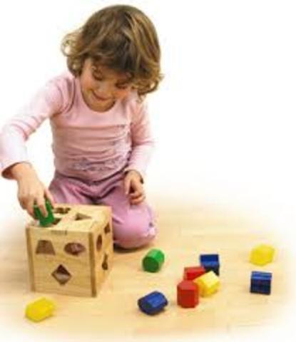 begins to sort shapes and colours