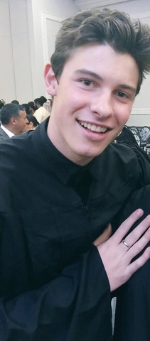 Shawn graduates high school.