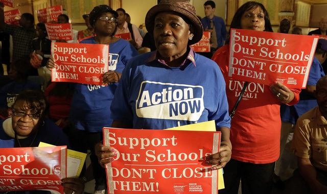 The Chicago Board of Education votes to close 50 schools.
