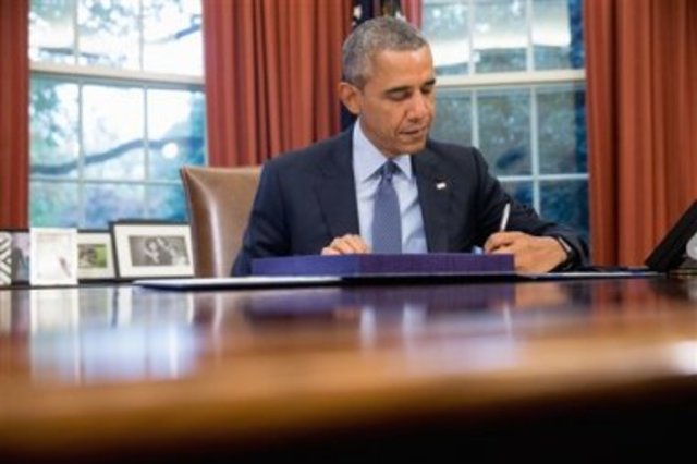 President Obama signs the 1.1 Trillion dollar bipartisan budget bill.