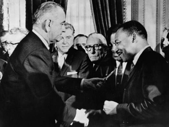 Lyndon B. Johnson signs Voting Rights Act