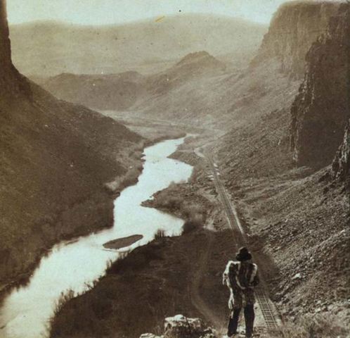 A Native American observers the completed Transcontinental railroad