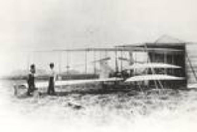 Orville Wright pilots first "airplane"