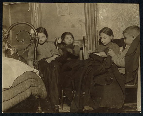 Tenement Houses in New York City Photo: Hine, Lewis. Three girls and a boy working on garments. February 1910. National Child Labor Committee Collection, Library of Congress, Washington, D.C.