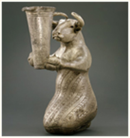 Kneeling Bull Holding A Spouted Vessel