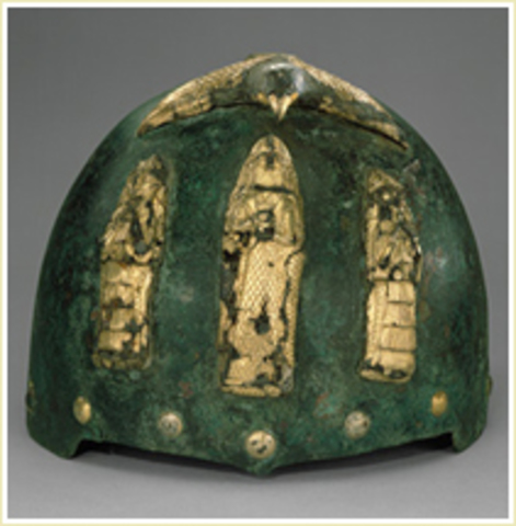 Helmet With Divine Figures Beneath A Bird With Outstretched Wings